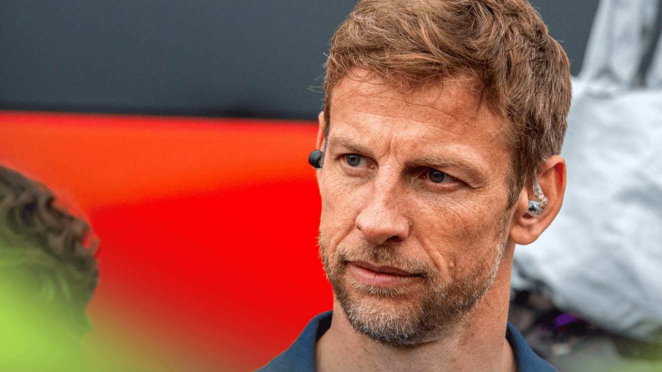 Jenson Button looks on in the paddock in Canada