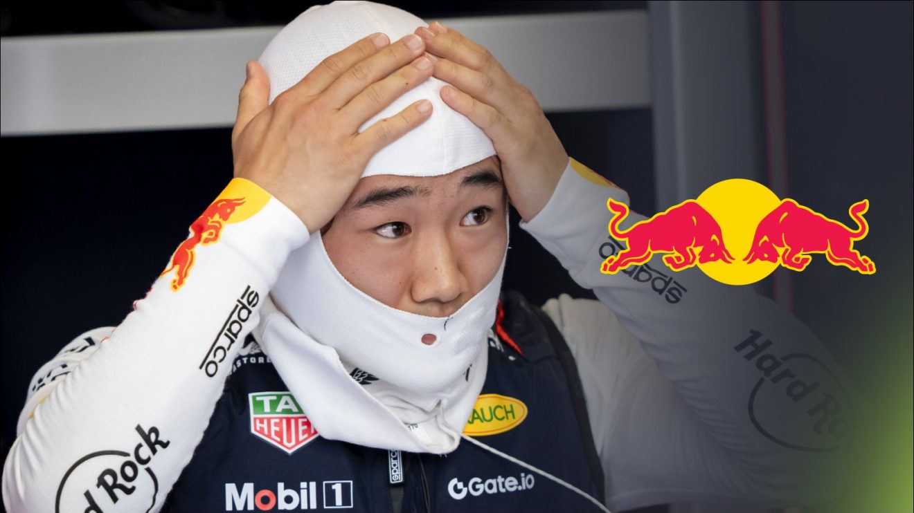 Yuki Tsunoda with his hands on his head in the Red Bull garage at the 2025 Spanish Grand Prix, with a Red Bull logo to his right