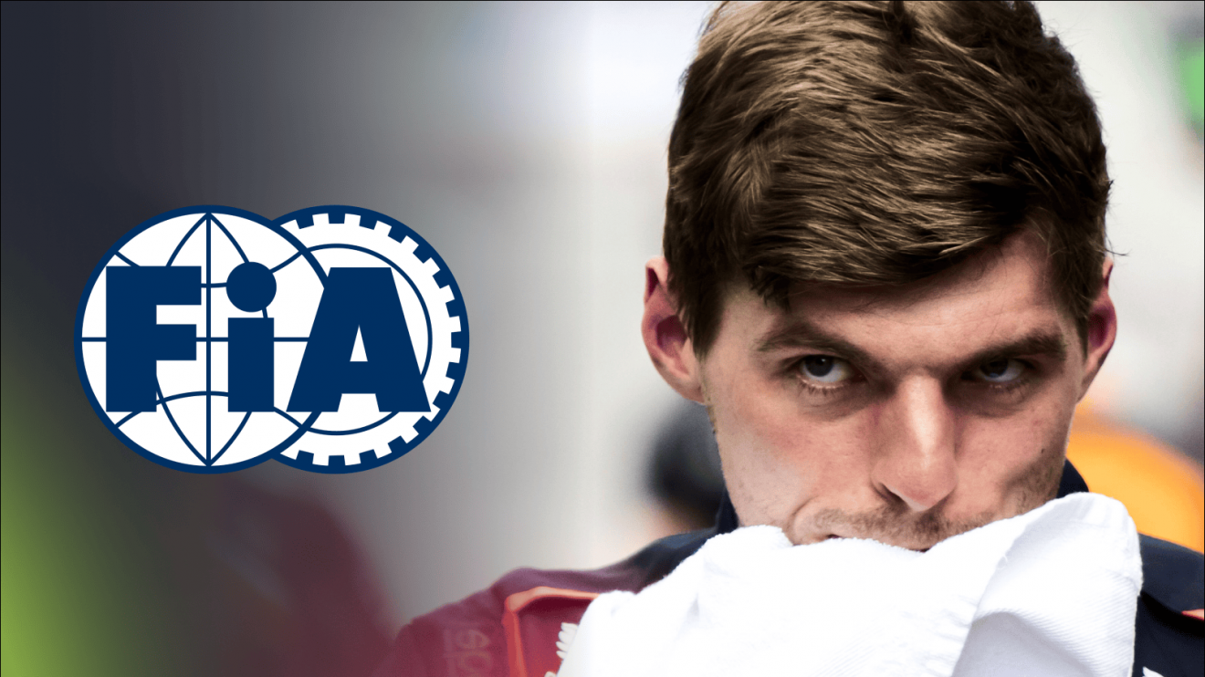 Max Verstappen wipes his face with a towel as a prominent FIA logo sits alongside him