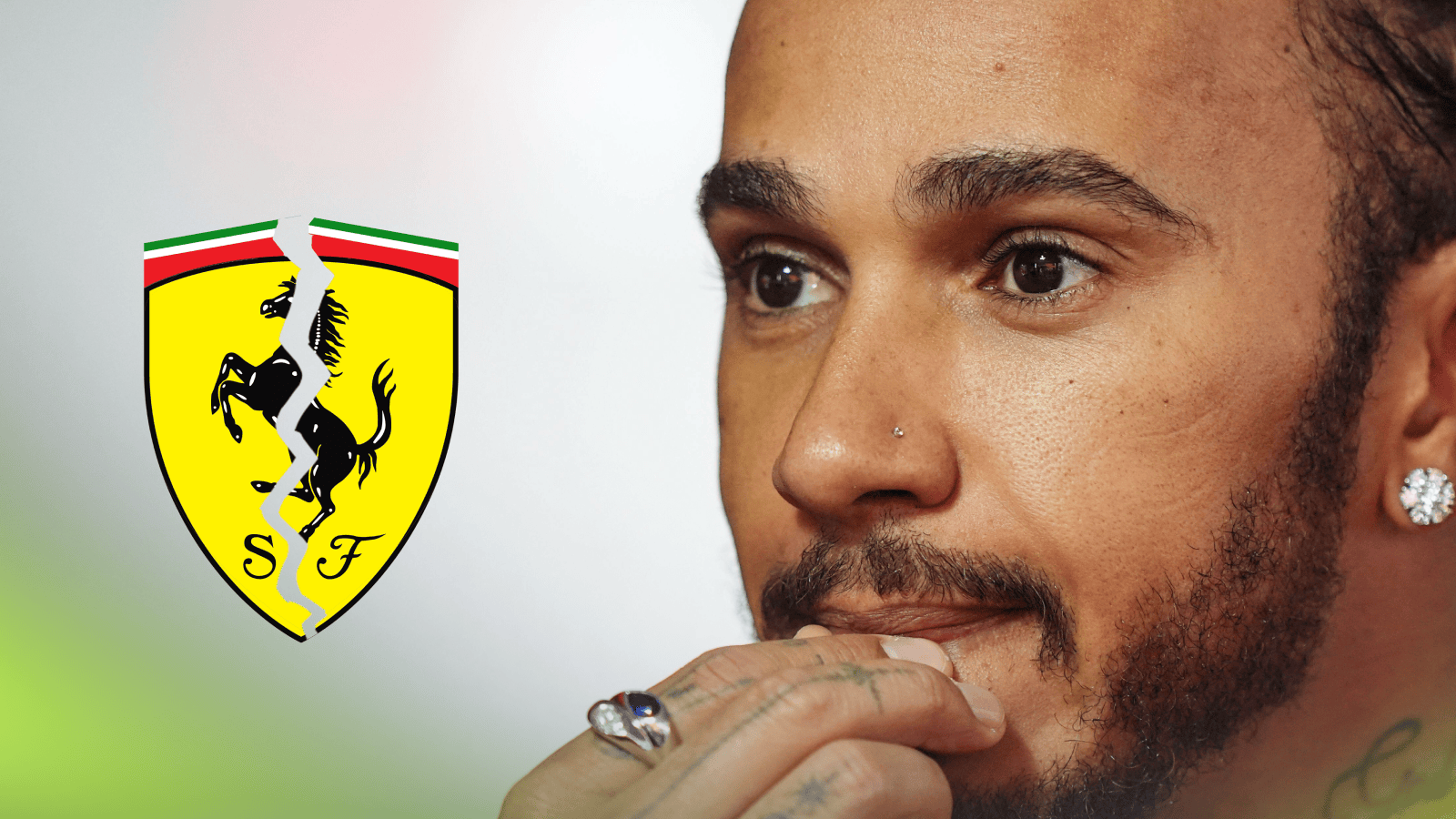 Lewis Hamilton holds his hand to his lips in concern with a cracked Ferrari badge alongside him