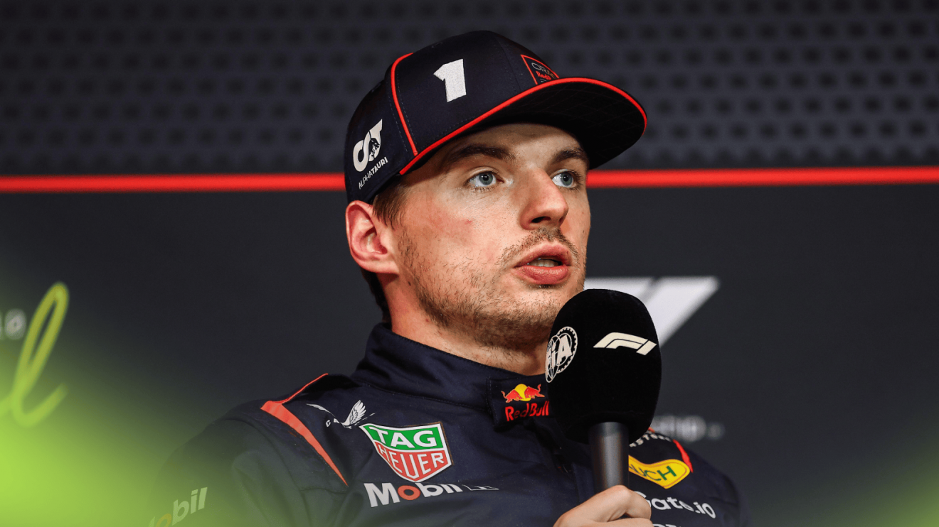 Max Verstappen speaks into a microphone during a press conference