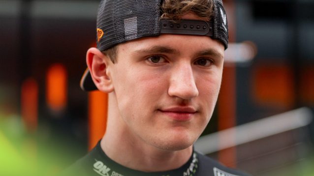 McLaren junior Alex Dunne looks into the camera at the 2025 Austrian Grand Prix