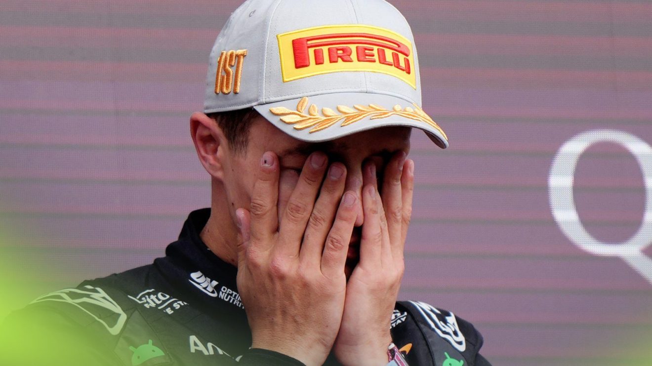 Lando Norris, McLaren, with his hands to his face on the podium after winning the 2025 British Grand Prix