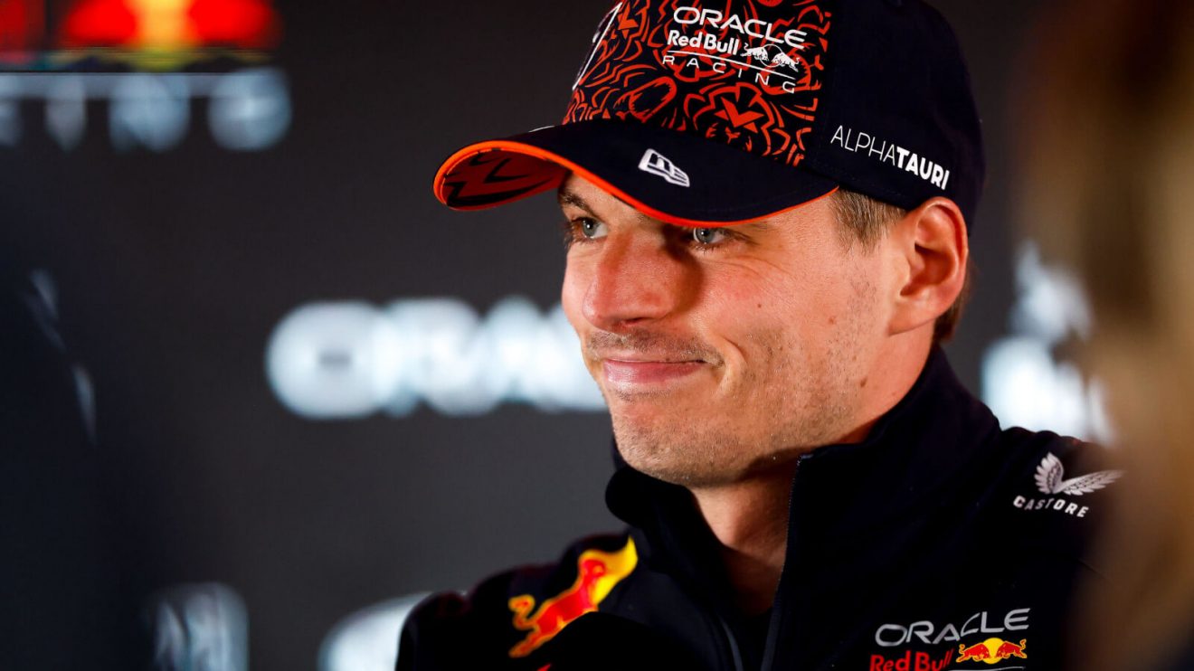 Max Verstappen smiles as he speaks with the media