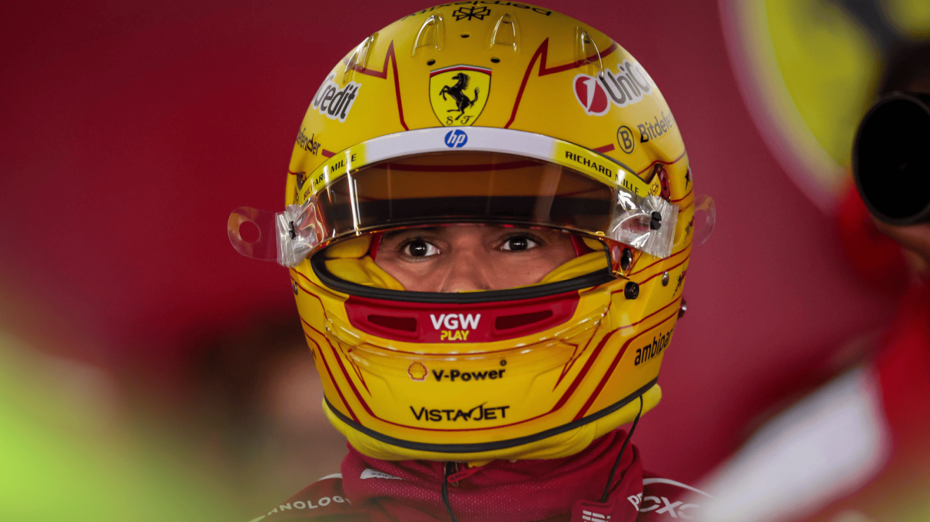 Lewis Hamilton's eyes visible through the visor of his helmet in the Ferrari garage