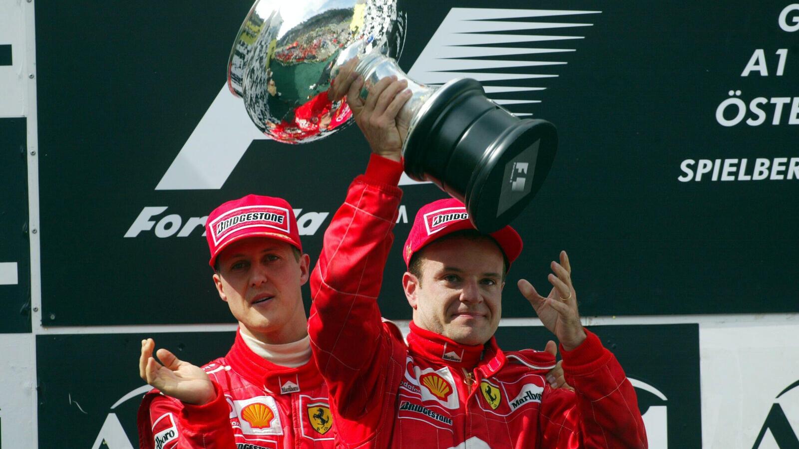 Moral victor Rubens Barrichello lifts the winners trophy despite finishing second.
