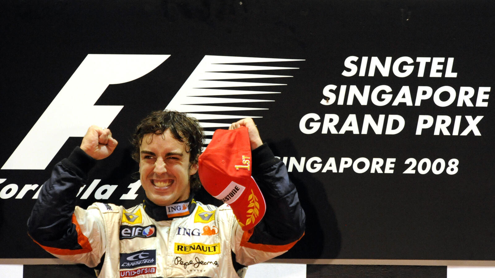 Fernando Alonso cheers on the podium after he won the Singapore Grand Prix.