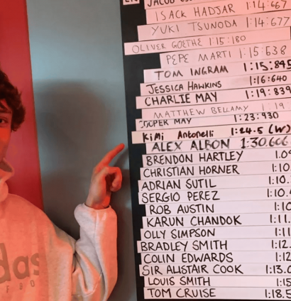 Andrea Kimi Antonelli smiles as he points to his name on a leaderboard at the Daytona kart circuit
