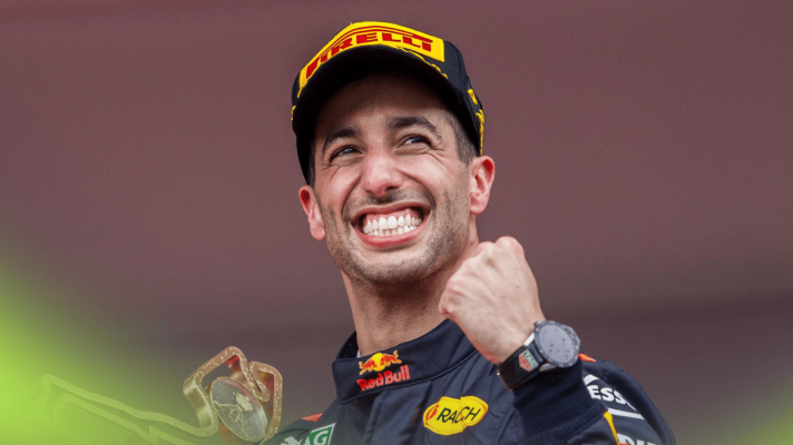 Daniel Ricciardo smiles and punches the air while clutching the winners' trophy at the 2018 Monaco Grand Prix