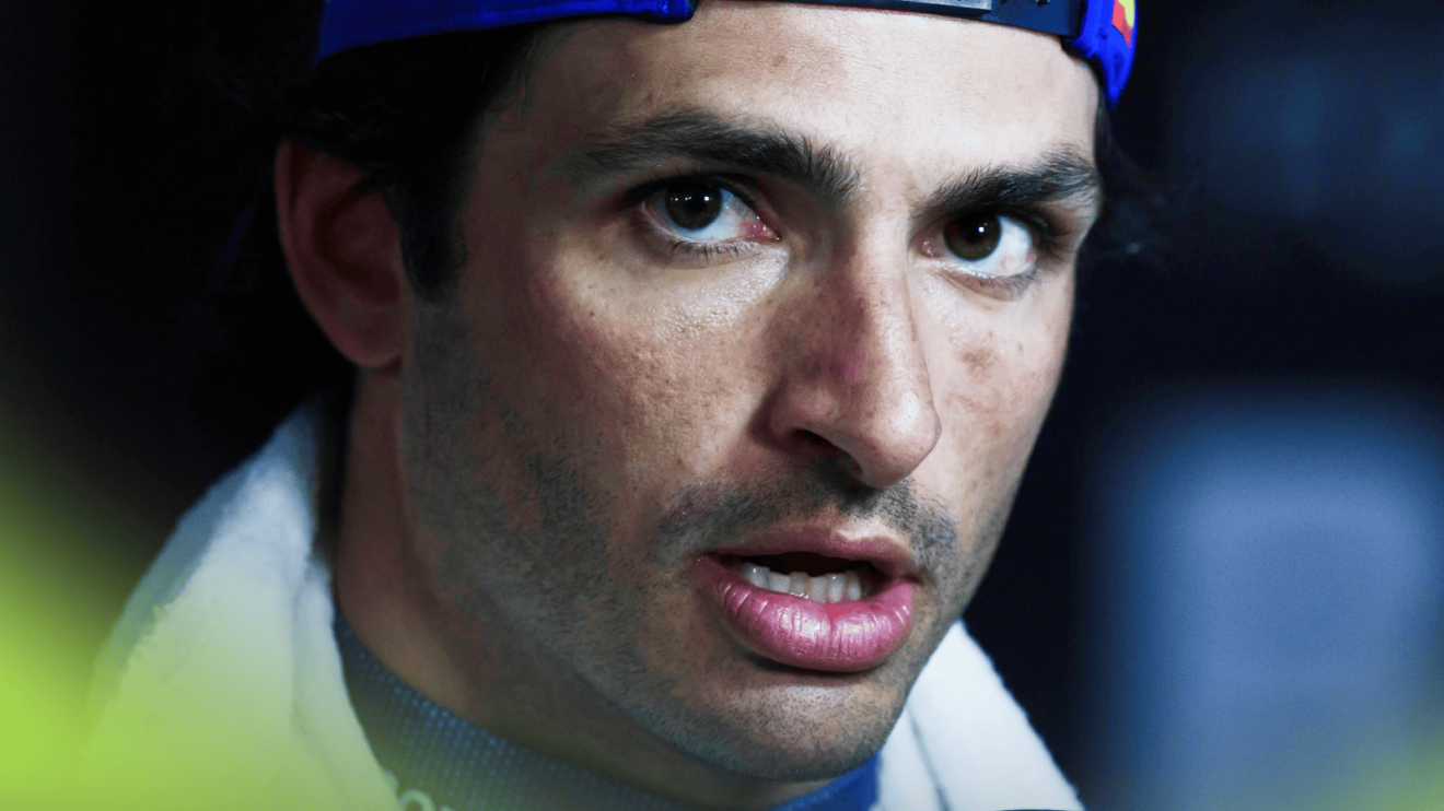 A close-up shot of Carlos Sainz facing the media