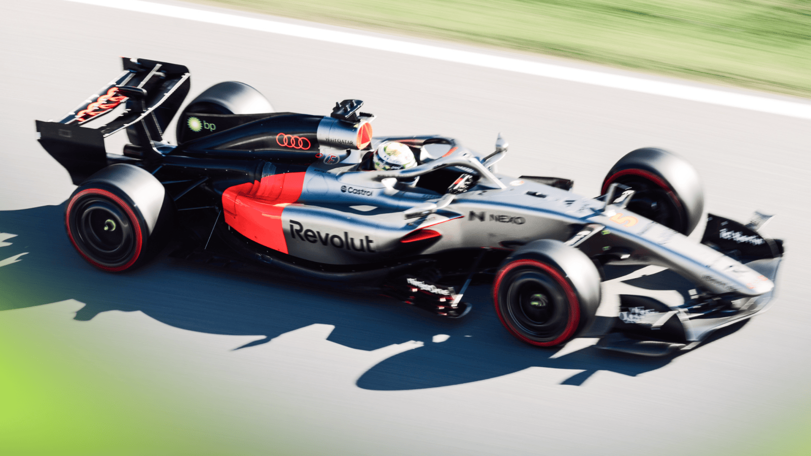 An action shot of Gabriel Bortoleto's Audi on track in a sunny Barcelona