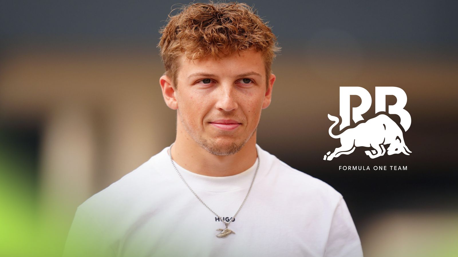Liam Lawson pictured at the 2025 Abu Dhabi Grand Prix, as a Racing Bulls logo appears on the right