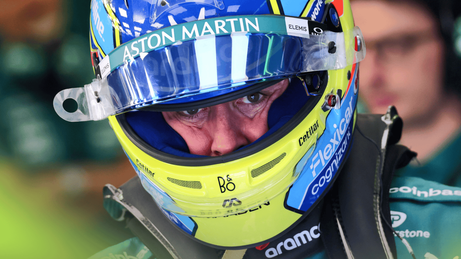 Fernando Alonso looks on through the open visor of his helmet