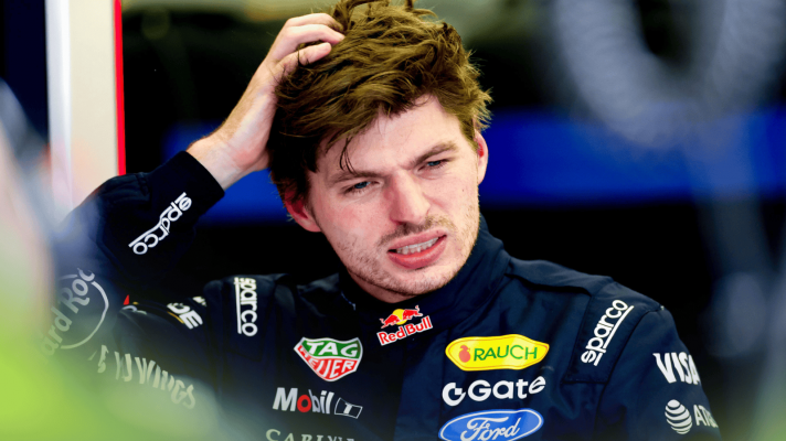 Max Verstappen scratches his head in the Red Bull garage