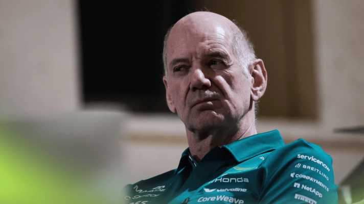 Adrian Newey cranes his head during a meeting in the paddock in Bahrain