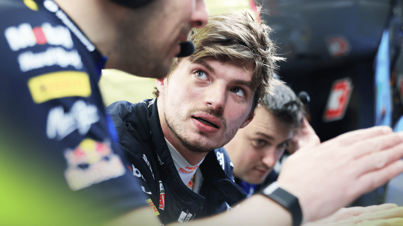 Max Verstappen in conversation with engineers in the Red Bull garage