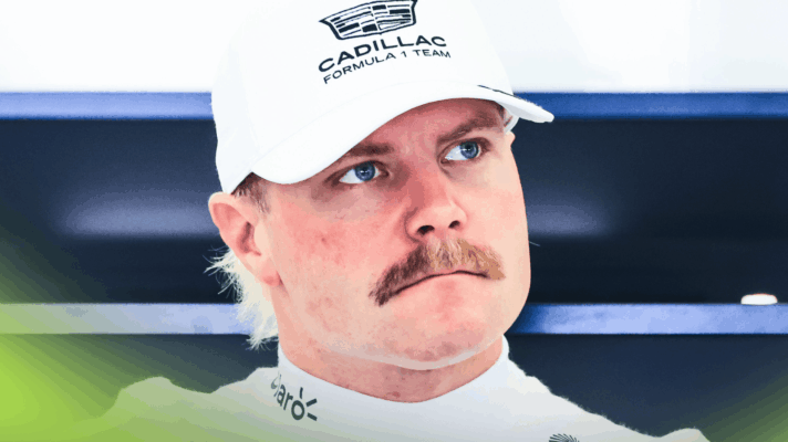 Valtteri Bottas wearing a white cap as he looks on in the Cadillac garage
