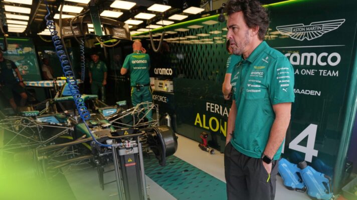 Fernando Alonso stands in front of the Aston Martin garage at the 2026 Australian Grand Prix