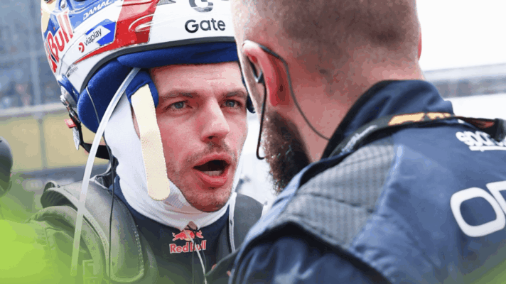 Max Verstappen balances his helmet on his head while talking to a Red Bull mechanic on the grid in Australia