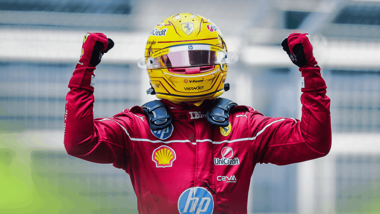 Lewis Hamilton holds both arms aloft in celebration after winning the sprint race in China
