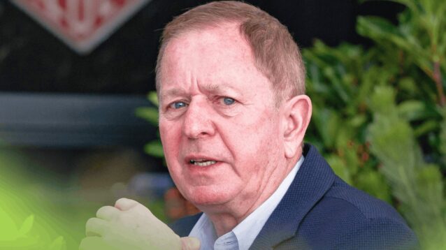 Martin Brundle eyes the camera while in conversation in the paddock