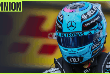 A close-up shot of George Russell wearing his helmet with an 'opinion' tab in the top-left corner