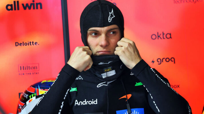 Oscar Piastri pulling on his fireproofs