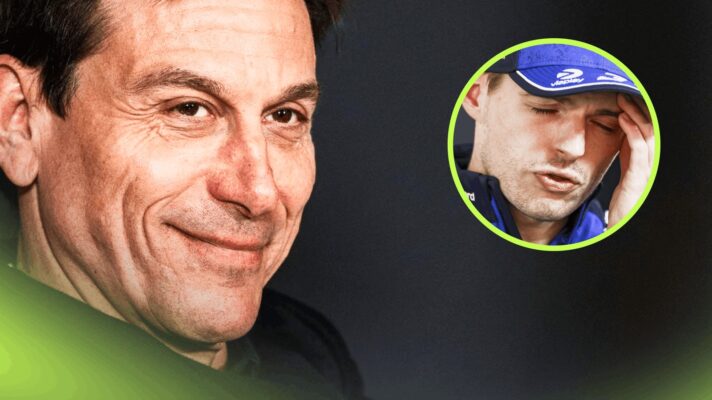 A close-up shot of Toto Wolff grinning in a press conference with an inset of Max Verstappen holding his hand to his head