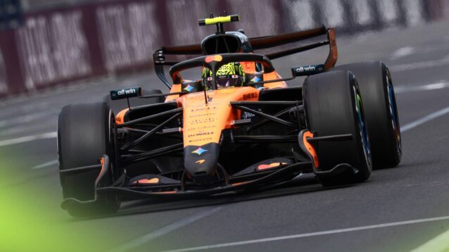 A ground-level shot of Lando Norris's McLaren with active aero open on the main straight in Melbourne