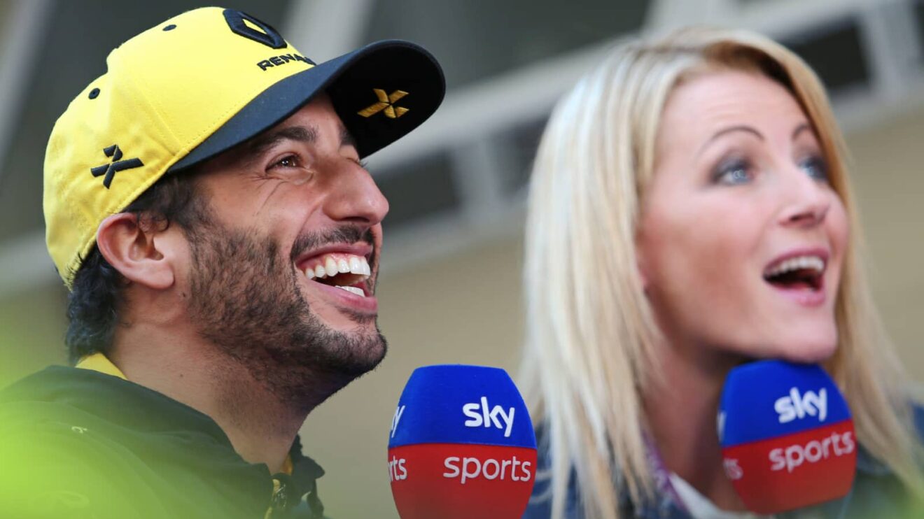 Daniel Ricciardo laughing along with presenter Rachel Brookes with the pair holding Sky Sports microphones