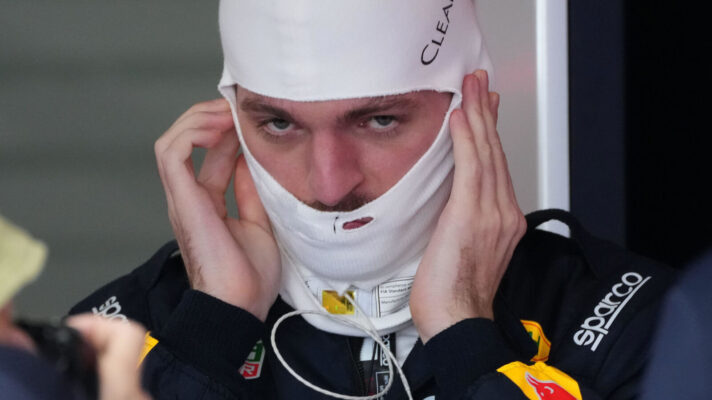 Max Verstappen in the Red Bull garage putting on his fireproofs
