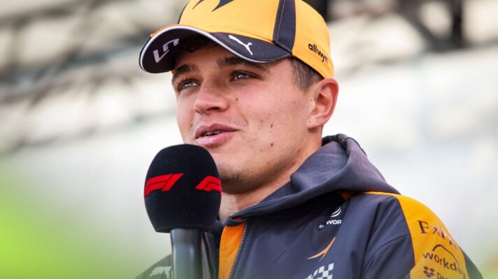 Lando Norris, McLaren, speaks into an 'F1' microphone at the 2026 Japanese Grand Prix