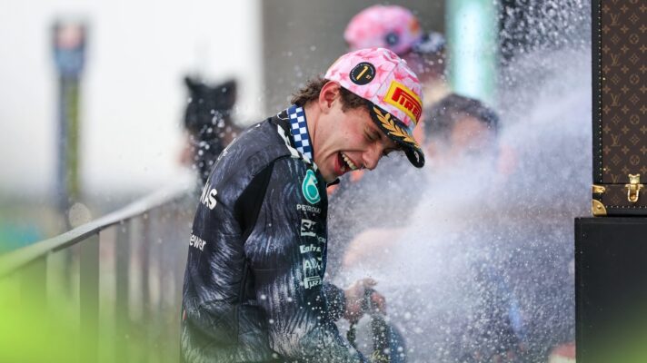 Kimi Antonelli smiles as he turns away from the champagne spray in the podium as he celebrates victory in the Japanese Grand Prix.