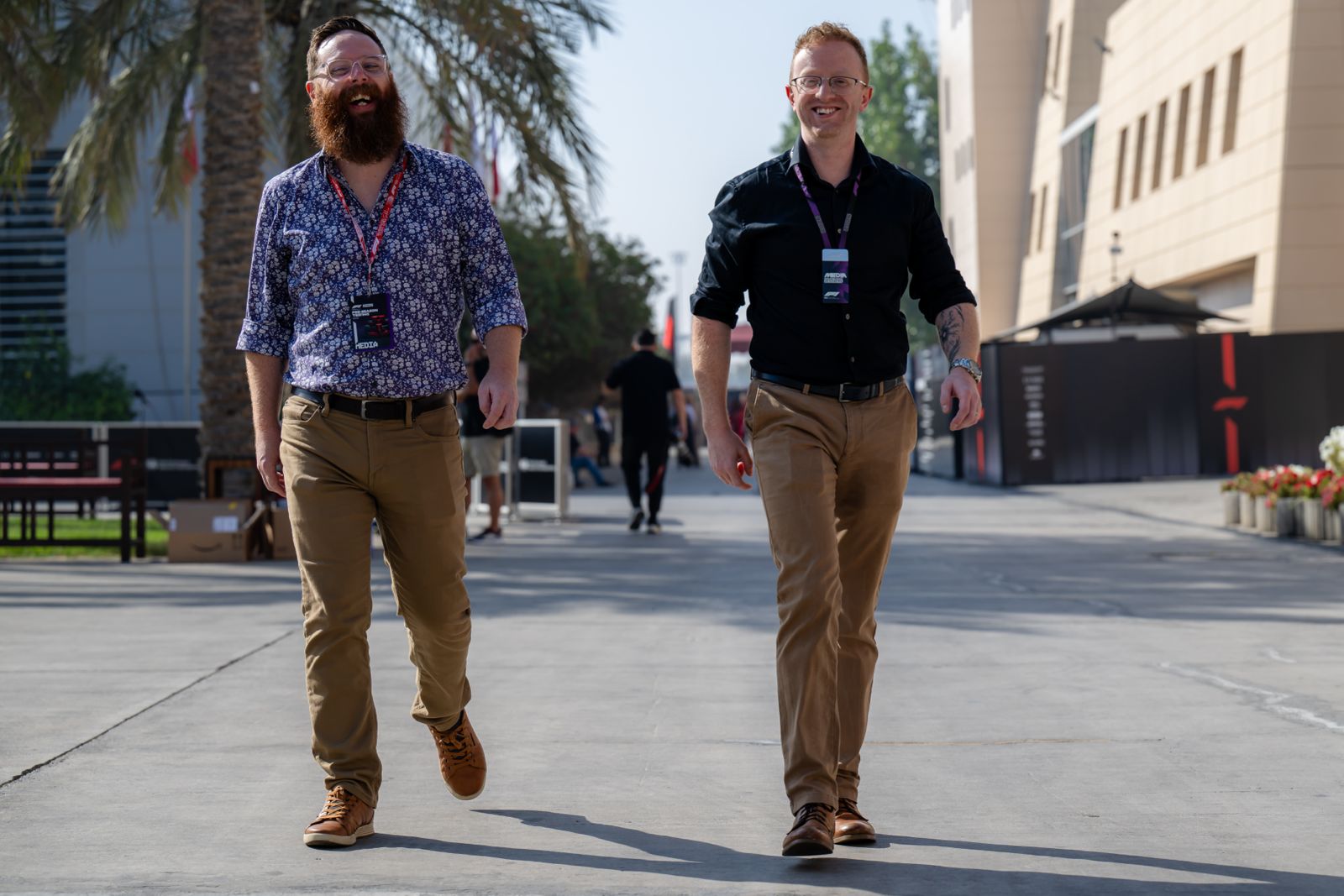 PlanetF1.com's Mat Coch and Thomas Maher smile as they walk through the Bahrain paddock during pre-season testing.