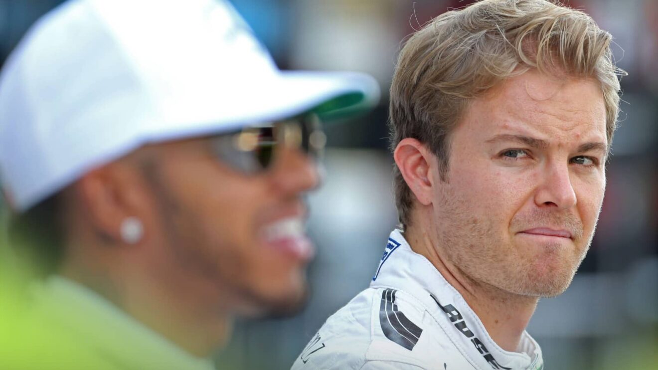 Nico Rosberg eyes a smiling Lewis Hamilton during a Mercedes photoshoot