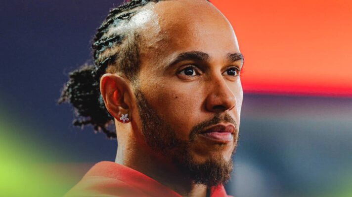 Lewis Hamilton looks on as he faces the media