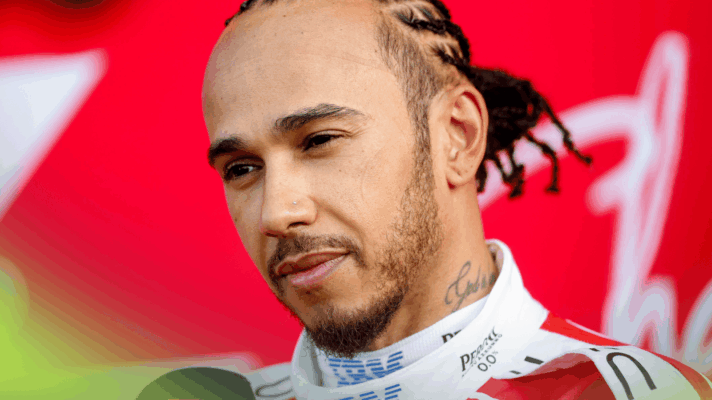 Lewis Hamilton looks on during an interview in parc ferme
