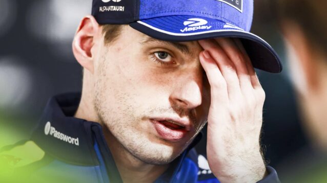 Max Verstappen holds his hand to his face with only one eye visible as he speaks to the media