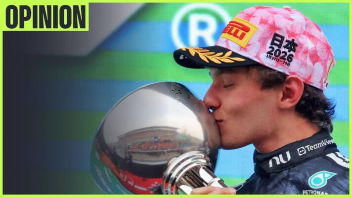 Kimi Antonelli kisses the winners' trophy on the podium with an 'opinion' tab in the top-left corner