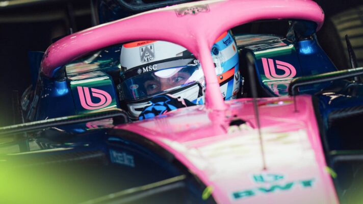 Franco Colapinto's eyes are visible through the visor of his helmet as he pulls out of the Alpine garage at Silverstone