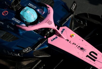 Looking down from above on Pierre Gasly in his Alpine in pit lane, with the nose, front axle, cockpit, and airbox visible.