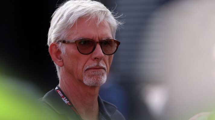 Damon Hill looks into the distance while wearing sunglasses in the Italian GP paddock in Monza.