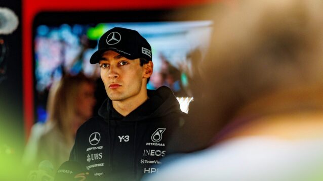 George Russell looking pensive during a post-race media interview.