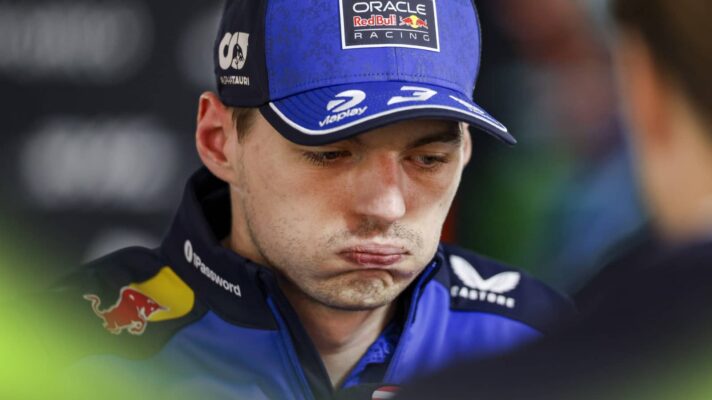 Max Verstappen puffs out his cheeks while speaking to the media