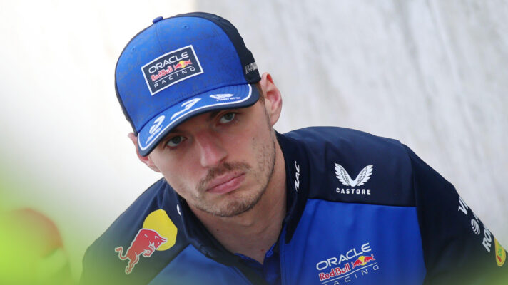A serious-looking Max Verstappen in Red Bull cap and jumper.