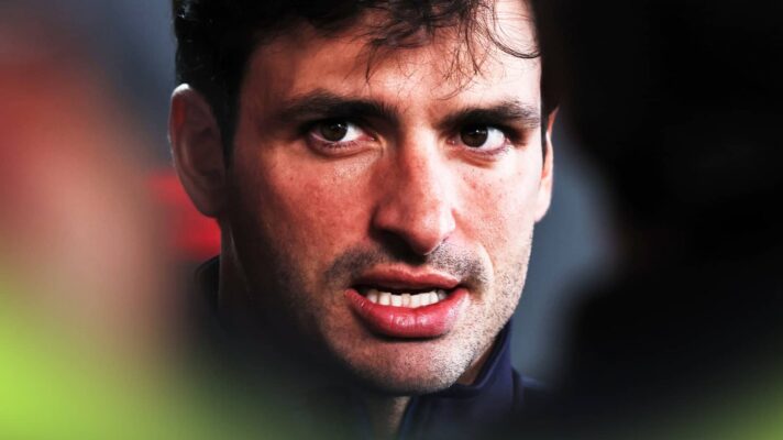 A close-up shot of Carlos Sainz speaking as he faces the media