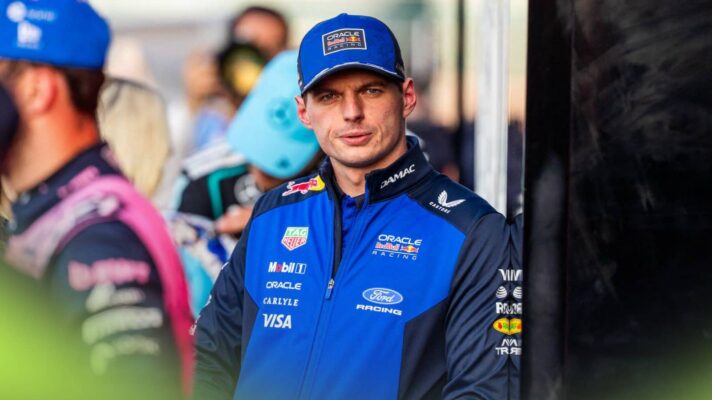 Max Verstappen eyes the camera while wearing Red Bull team kit in the Suzuka paddock