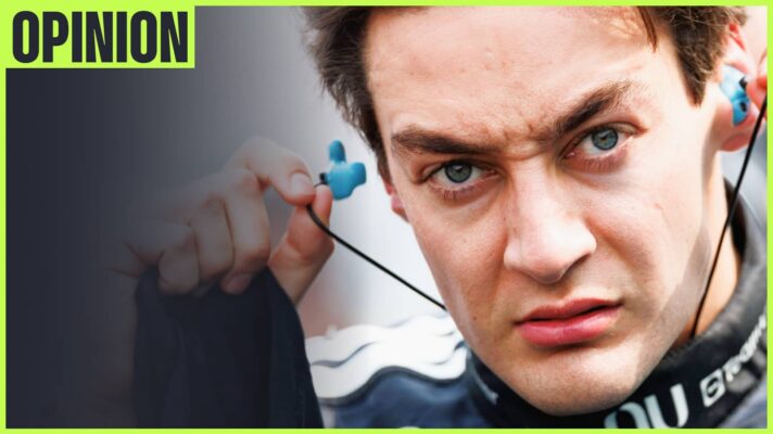 A close-up shot of George Russell inserting his earplugs with an 'opinion' tab in the top-left corner