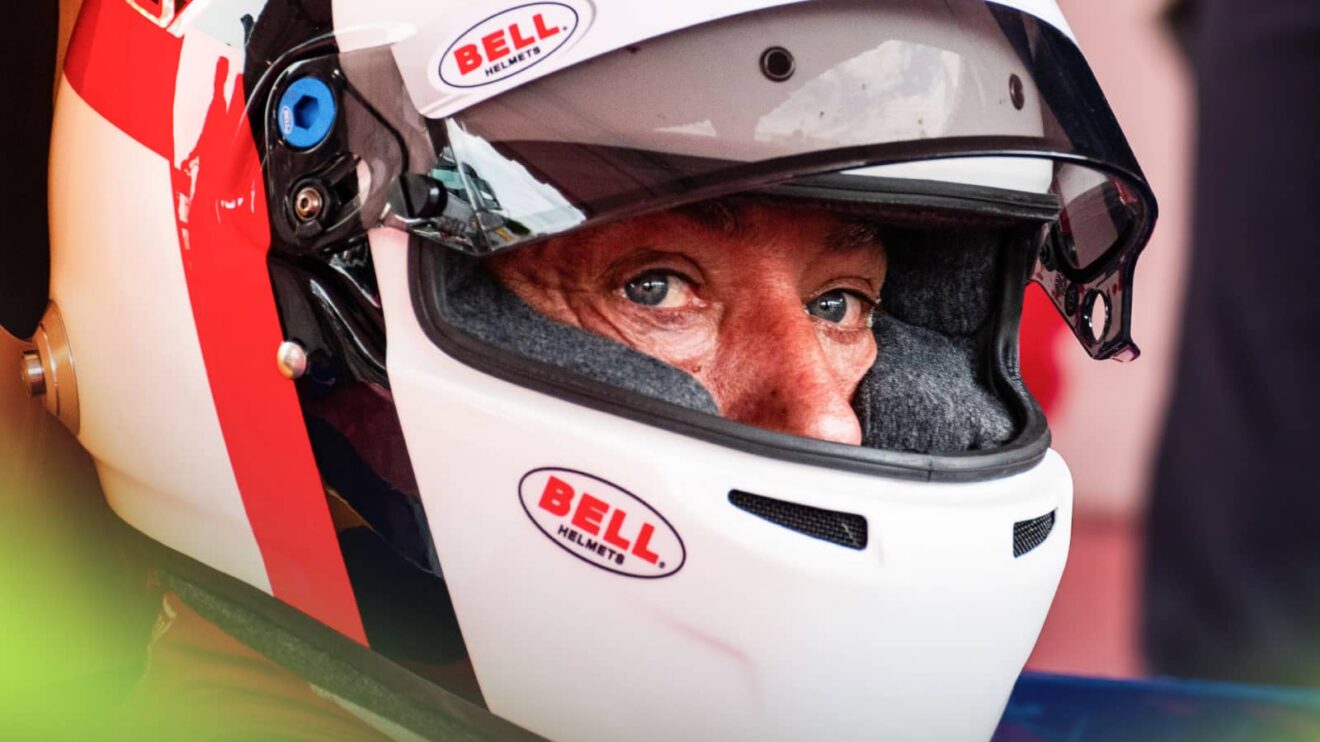 Jean Alesi's eyes visible through the open visor of his helmet