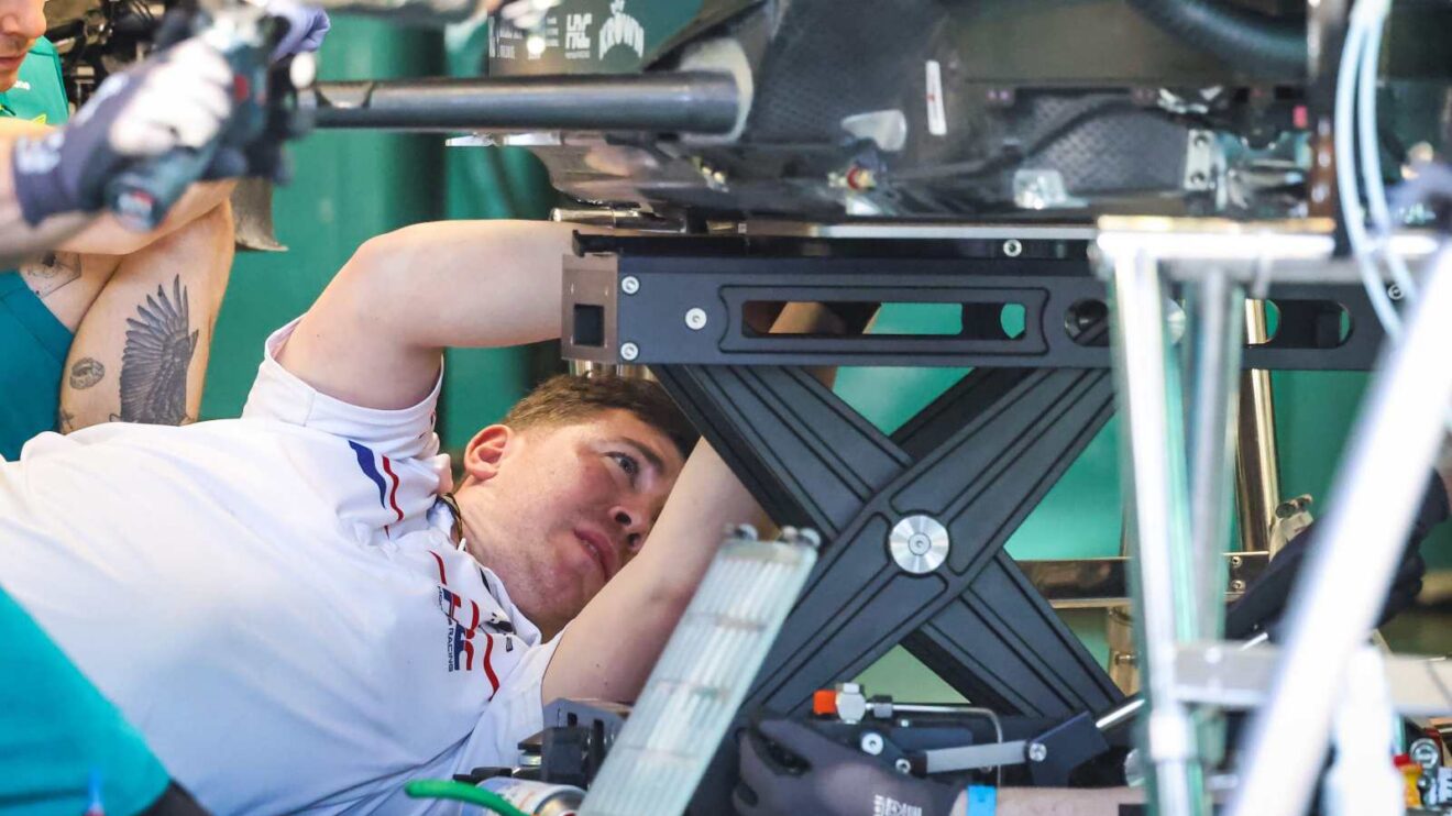 A Honda engineer works on the Aston Martin AMR26.